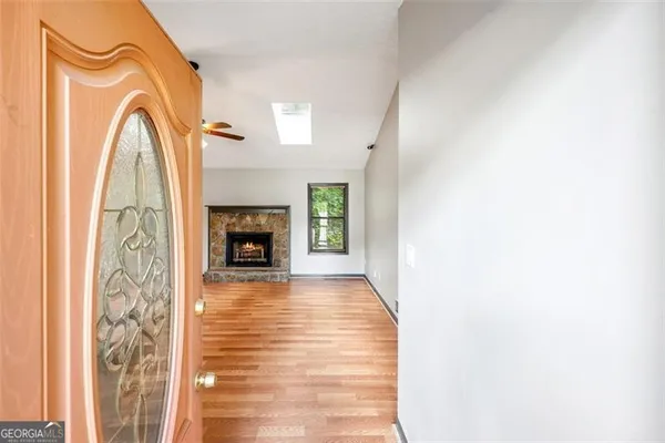 a view of a livingroom with wooden floor and a fireplace