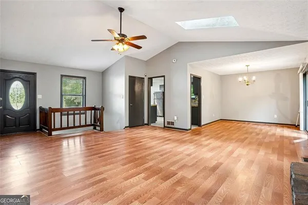 a view of a room with wooden floor and window