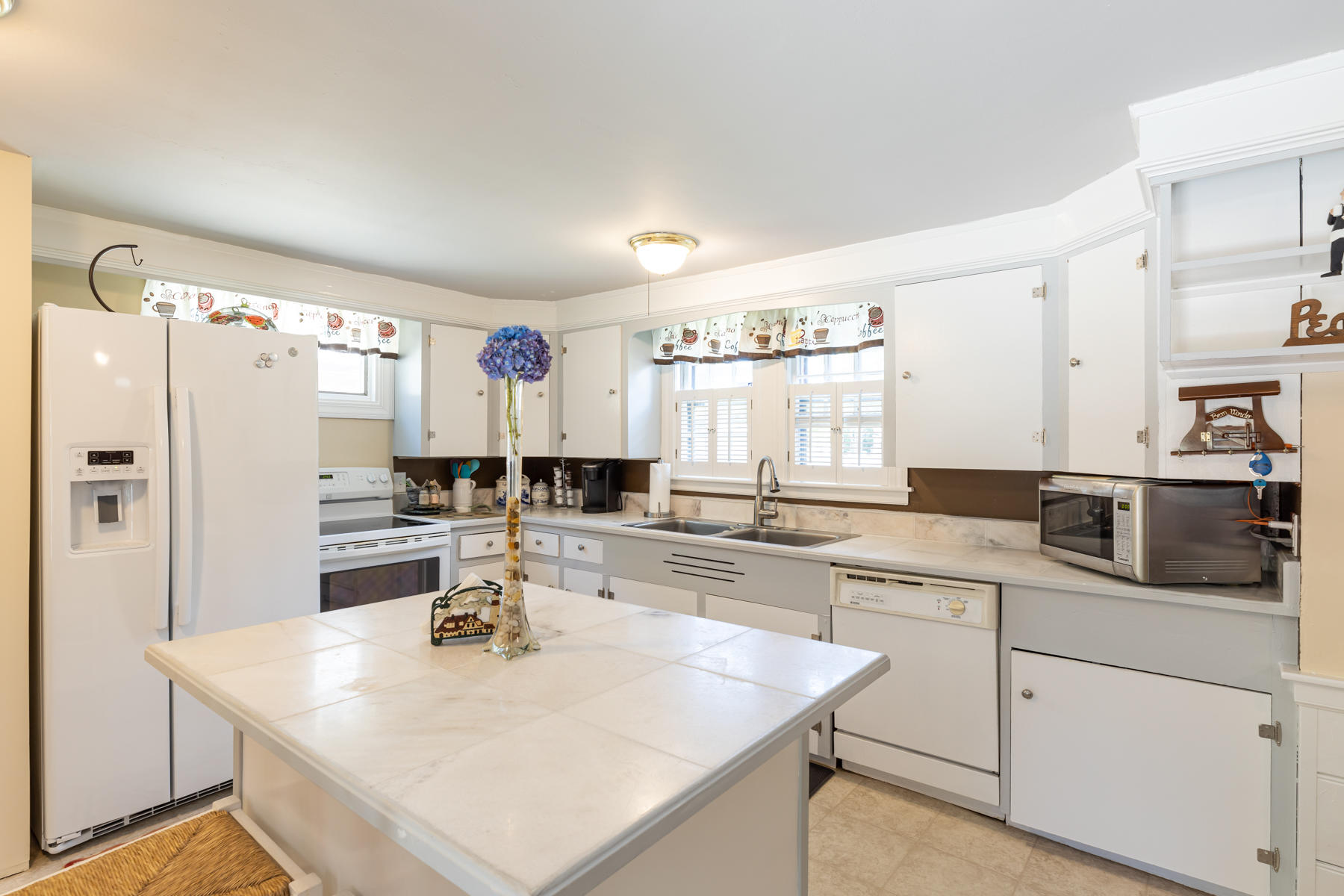 64 Murphy Road Hyannis, MA 02601 - Photo 3 of 64 a kitchen with a sink a stove a refrigerator and white cabinets