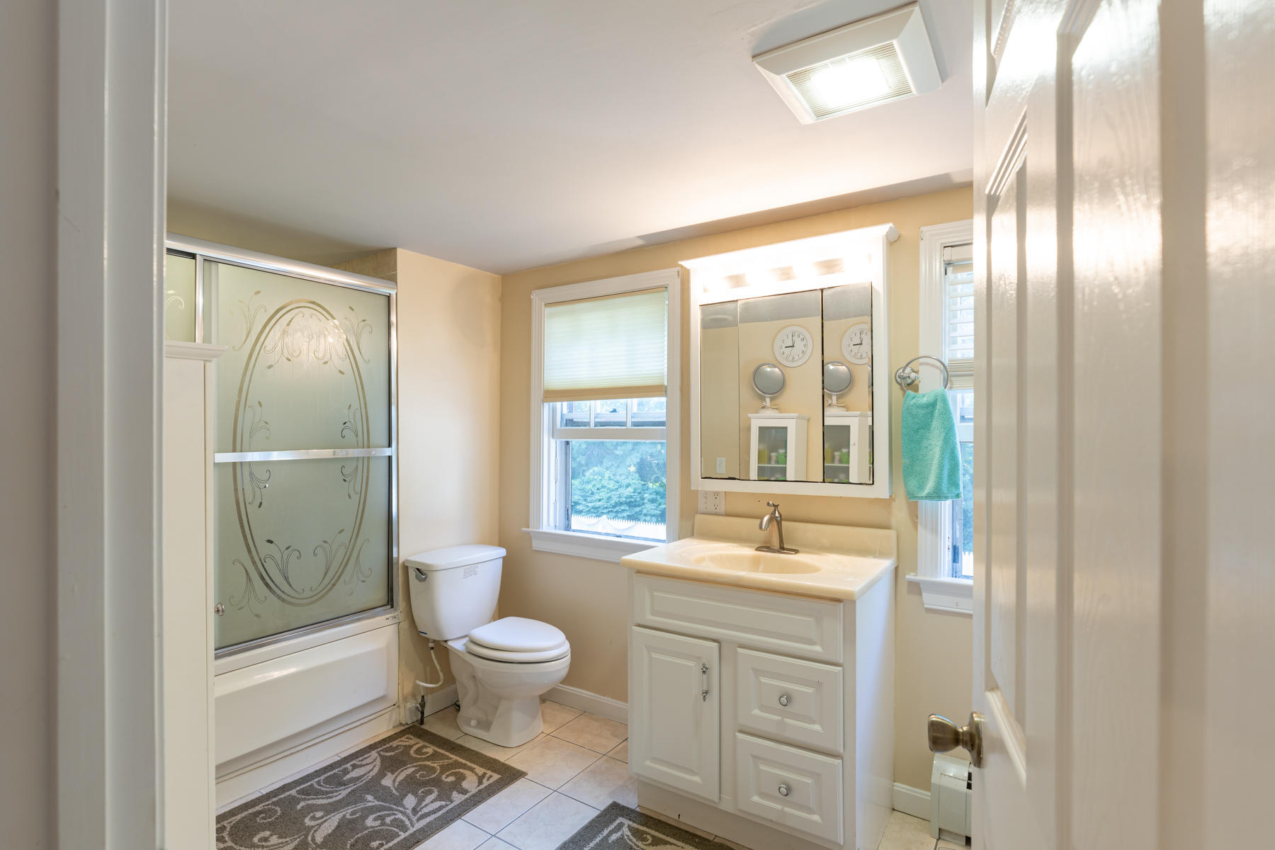 64 Murphy Road Hyannis, MA 02601 - Photo 41 of 64 a bathroom with a granite countertop sink toilet a large mirror a vanity and next to a window