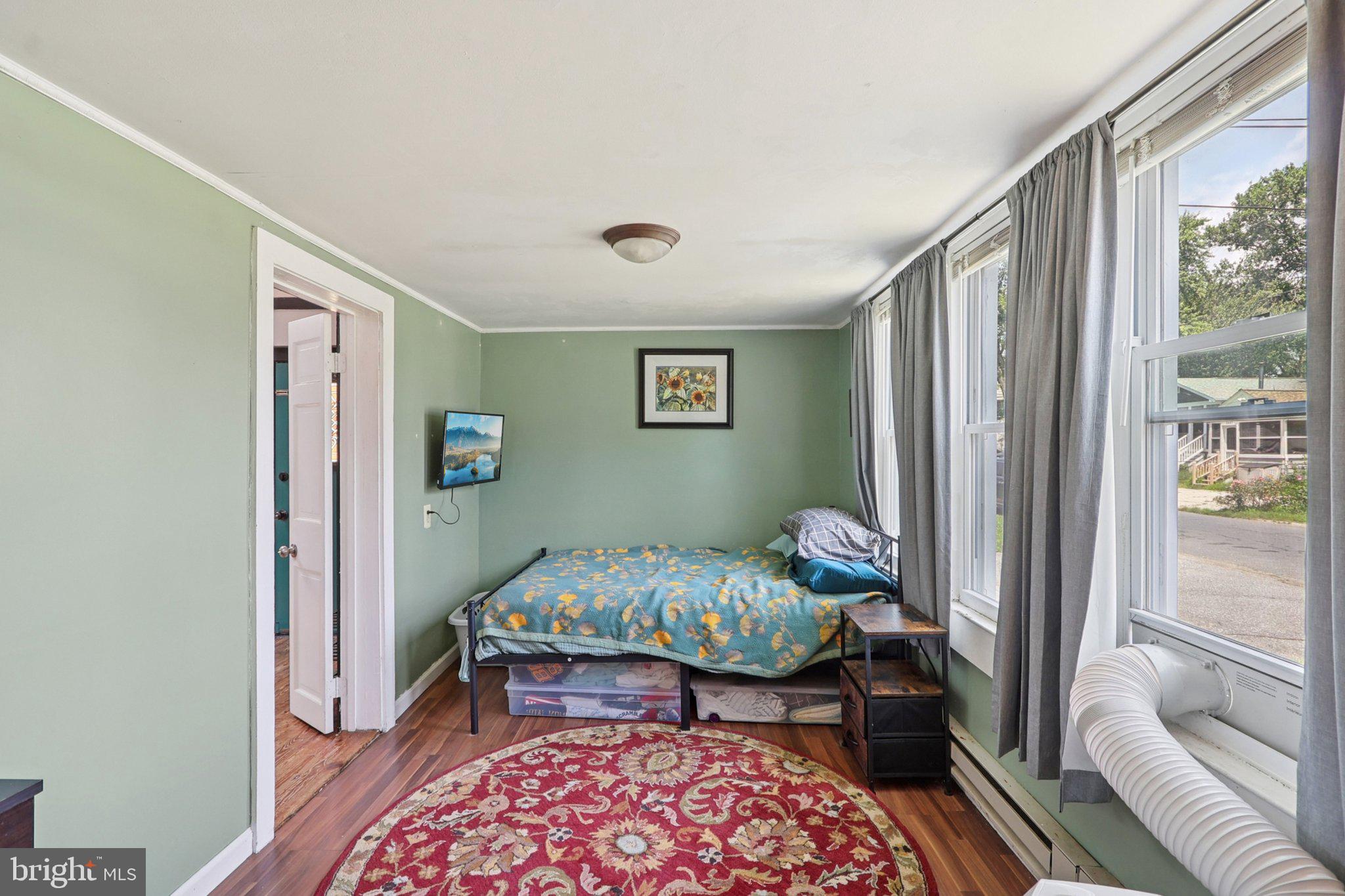 1610 Midland Road Edgewater, MD 21037 - Photo 13 of 27 a bedroom with a bed and wooden floor