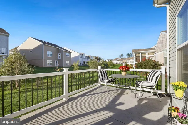 a view of a chair and tables in the balcony