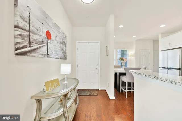 a kitchen with stainless steel appliances kitchen island granite countertop a sink and a refrigerator