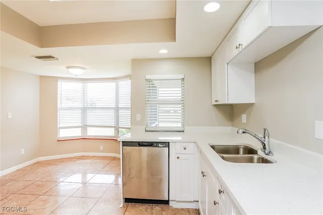 a kitchen with a sink a stove and cabinets