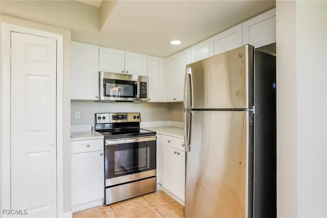a kitchen with a refrigerator stove and microwave
