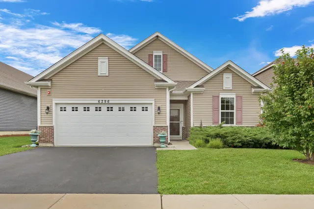 a view of a house with a yard and garage