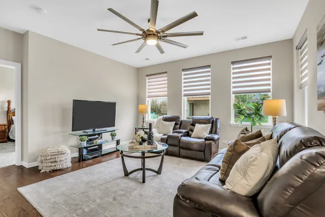 a living room with furniture a window and a flat screen tv