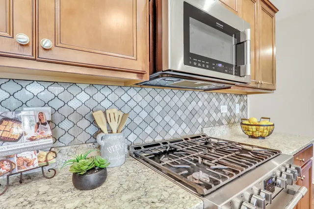a stove top oven sitting inside of a kitchen