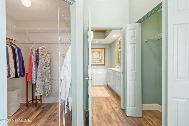 a view of a hallway with wooden floor and entryway