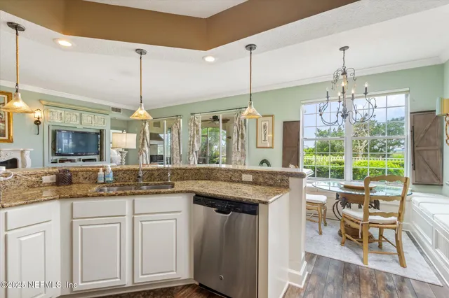 a kitchen with kitchen island granite countertop dining table chairs and granite counter tops