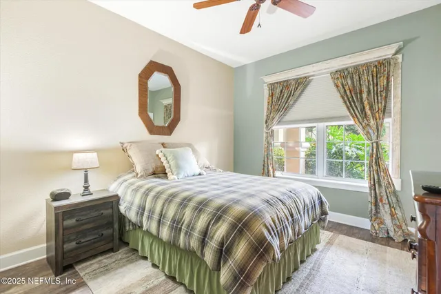 a bedroom with a bed and a mirror on the dresser