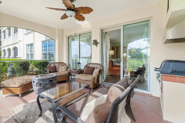 a living room with furniture and a floor to ceiling window