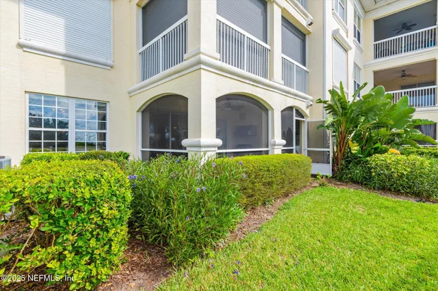 a bedroom with a bed and glass window