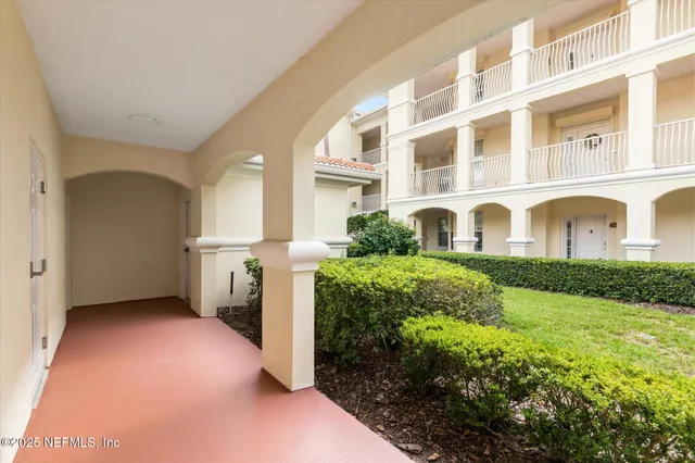 a view of a hallway with furniture and a yard