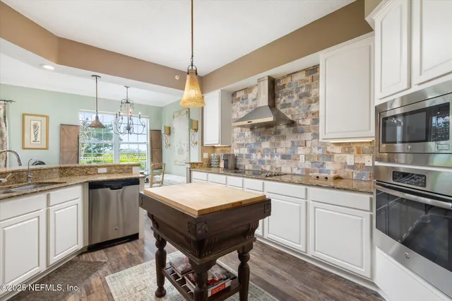 a large kitchen with a sink and cabinets