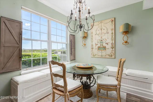 a view of a dining room with furniture wooden floor and chandelier