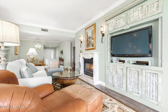 a living room with furniture a flat screen tv and a floor to ceiling window