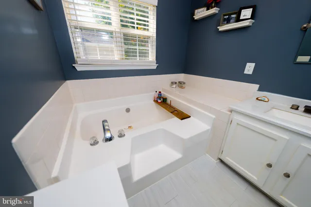 a bathroom with a bathtub and a window