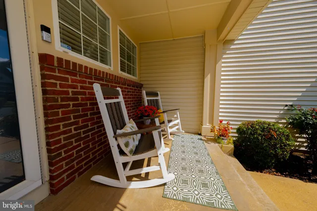 a view of a balcony with chairs and potted plants