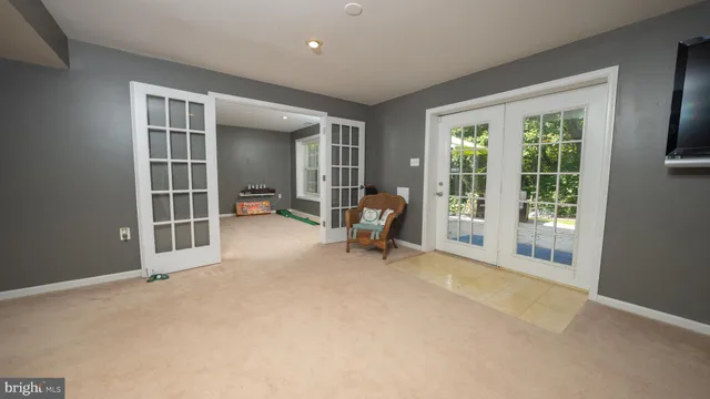 a view of a livingroom with furniture and a large window