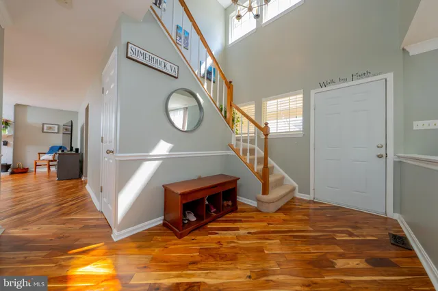 a view of a livingroom with furniture and staircase