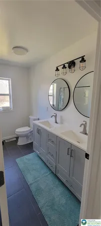 a bathroom with a bathtub and a window