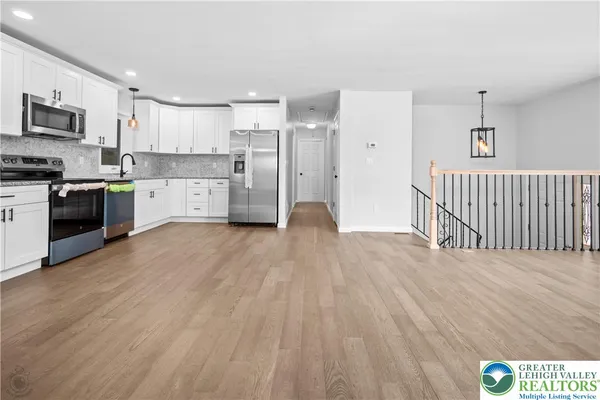 a kitchen with stainless steel appliances and white cabinets