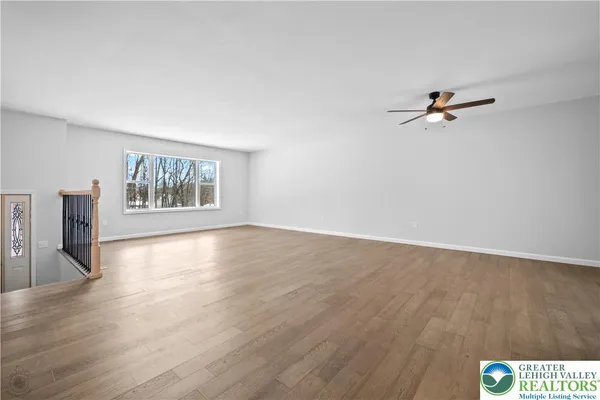 a view of backyard of house with seating area
