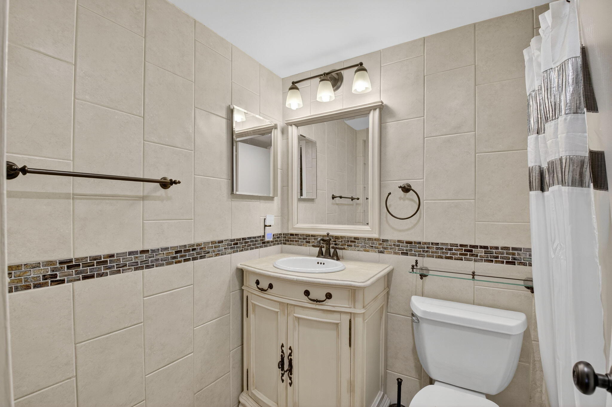125 Suffolk C Boca Raton, FL 33434 - Photo 17 of 50 a bathroom with a sink a toilet and a mirror