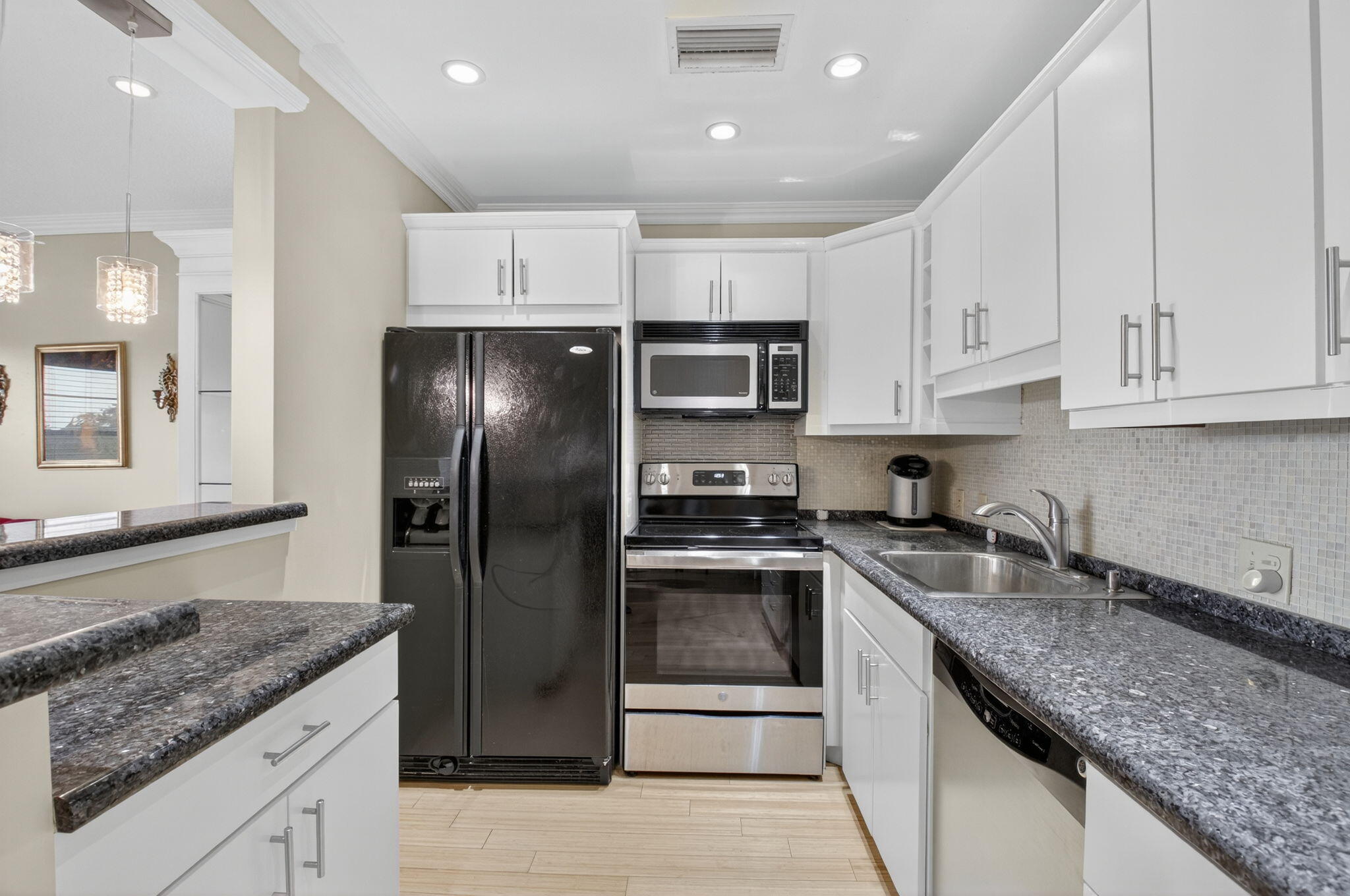 125 Suffolk C Boca Raton, FL 33434 - Photo 2 of 50 a kitchen with stainless steel appliances granite countertop a sink stove and refrigerator
