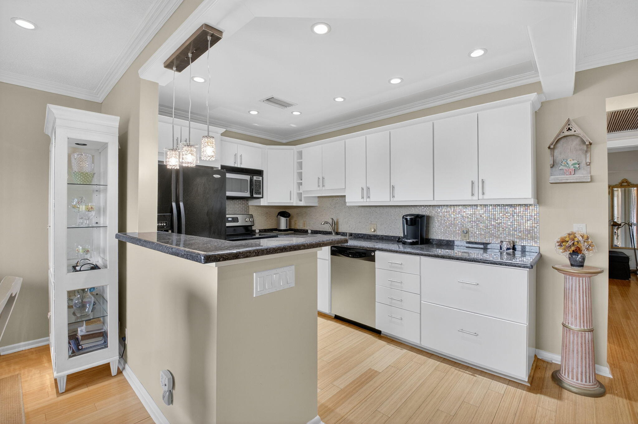 125 Suffolk C Boca Raton, FL 33434 - Photo 3 of 50 a kitchen with stainless steel appliances granite countertop a refrigerator and a stove top oven