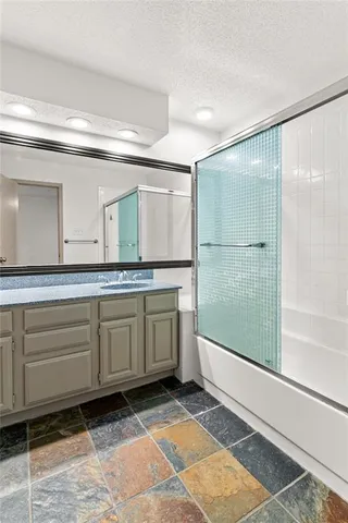 a bathroom with a granite countertop sink mirror and