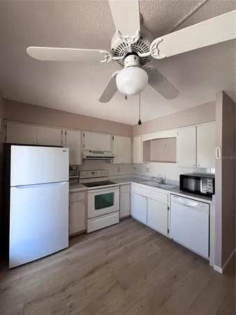 a kitchen with a sink stainless steel appliances and cabinets