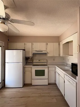 a kitchen with a stove a refrigerator and a sink