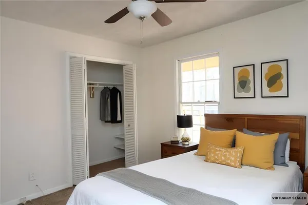 a bedroom with a bed and a painting on the wall