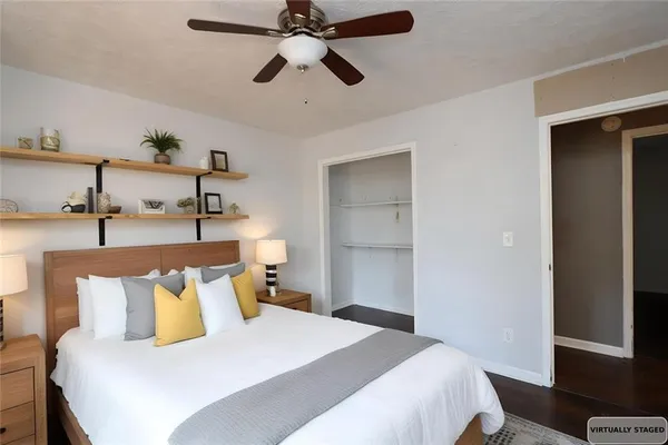 a bedroom with a bed and ceiling fan