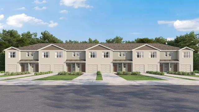 a view of a white house with a yard