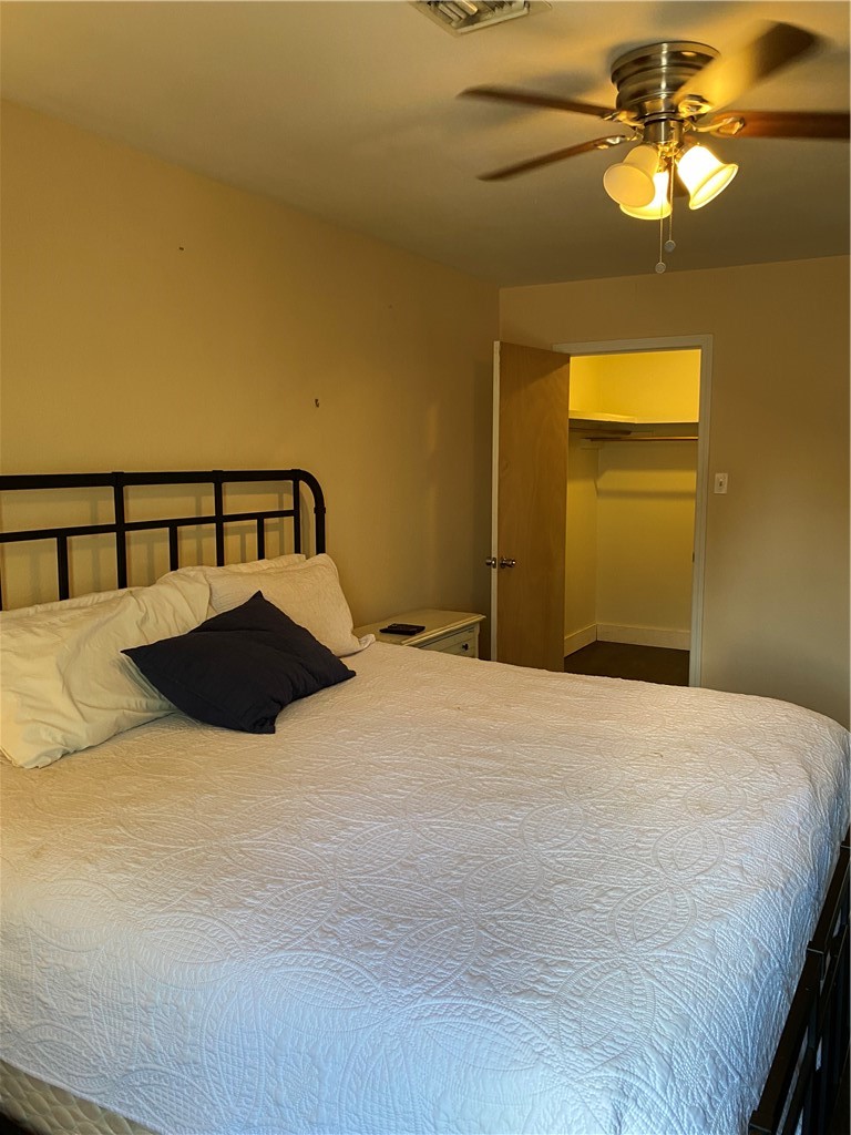 196 East Lakeview Trail Sandia, TX 78383 - Photo 12 of 39 a bedroom with a bed and a chandelier