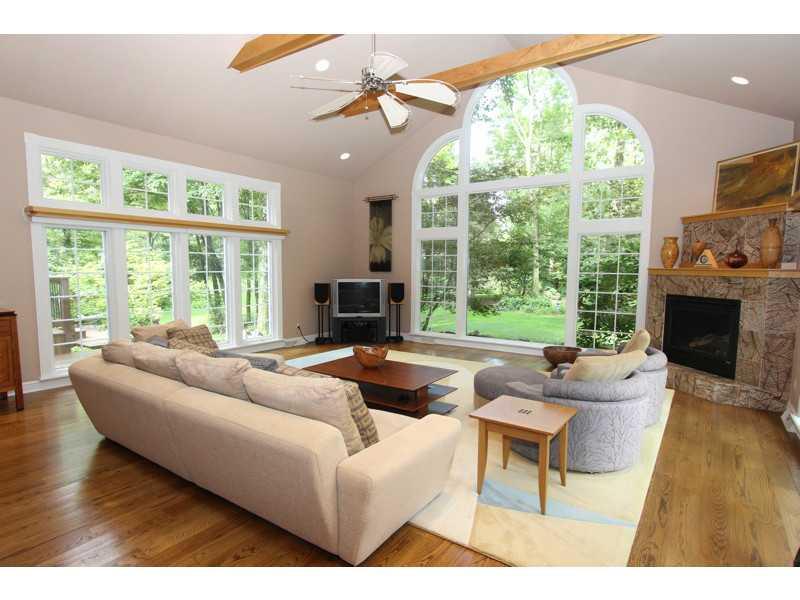 Living Room. LIVINGROOM/GREAT ROOM VAULTED CEILING WITH EXPOSED BEAMS. LARGE WINDOWS ON EACH WALL. GAS LOG FIREPLACE. OPEN TO DININGROOM. HARDWOOD FLOORING.