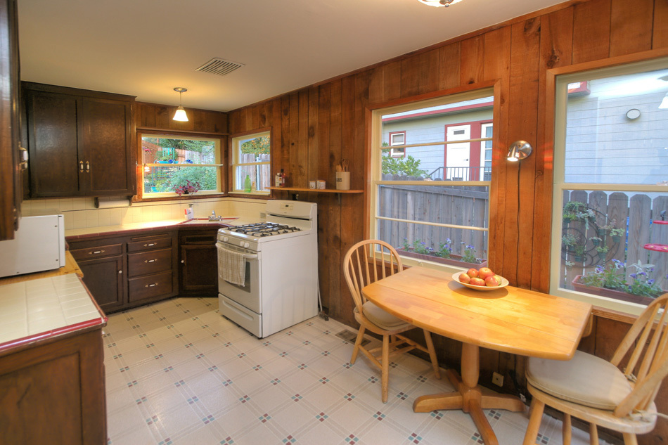 1064 Cheltenham Road Santa Barbara, CA 93105 - Photo 9 of 15 a kitchen with a table chairs sink and cabinets