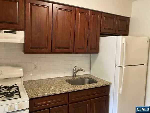 a white refrigerator freezer sitting in a kitchen