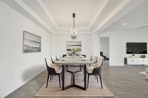 a kitchen with granite countertop white cabinets and stainless steel appliances