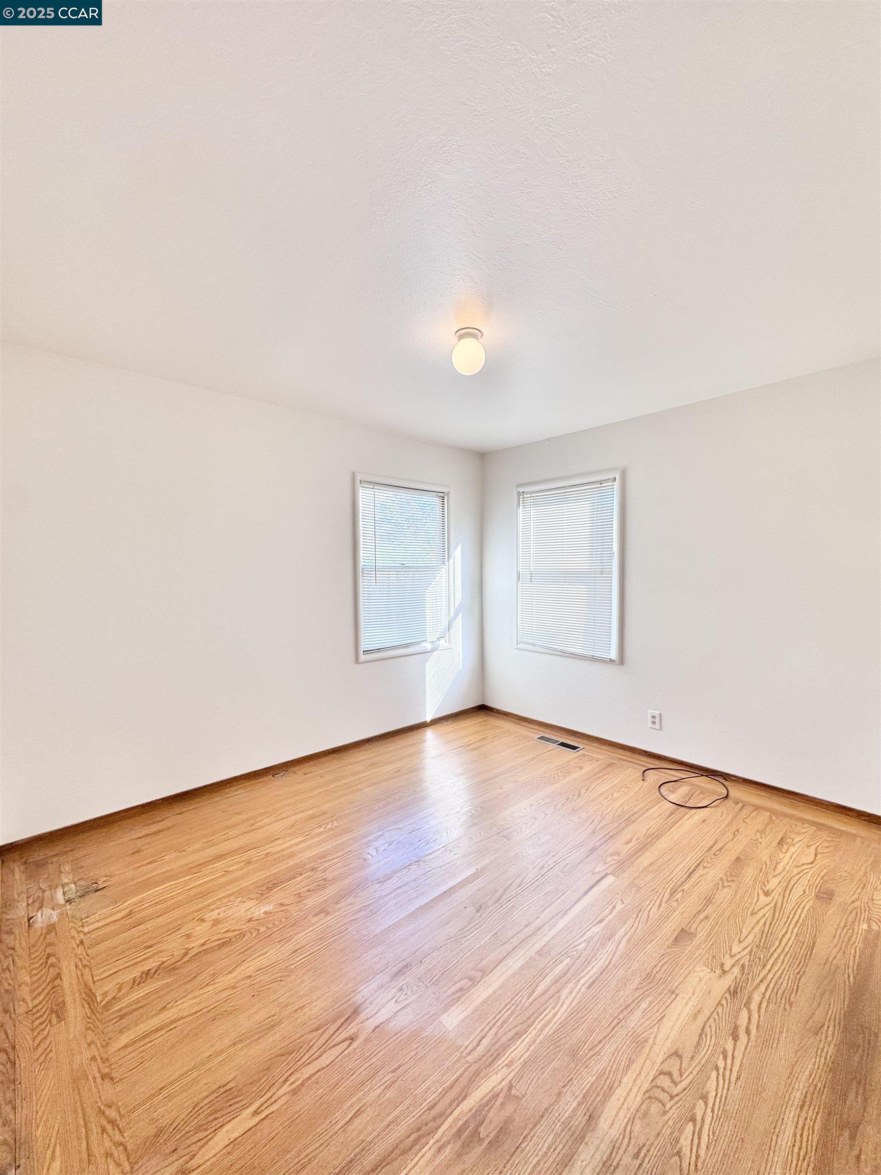 1834 Venice Drive Concord, CA 94519 - Photo 12 of 25 a view of an empty room with wooden floor and a window