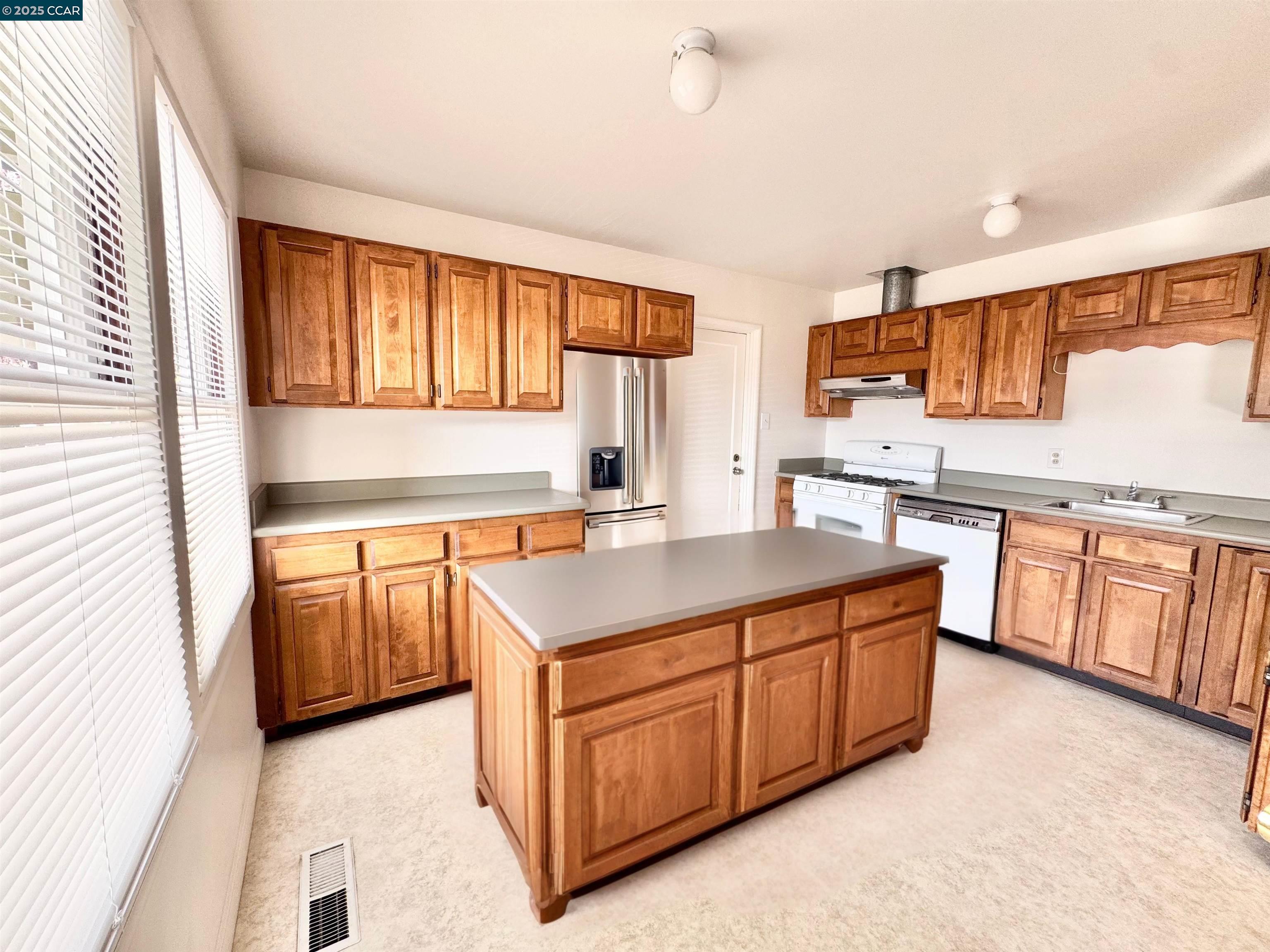 1834 Venice Drive Concord, CA 94519 - Photo 13 of 25 a kitchen with stainless steel appliances granite countertop a stove a sink and a refrigerator
