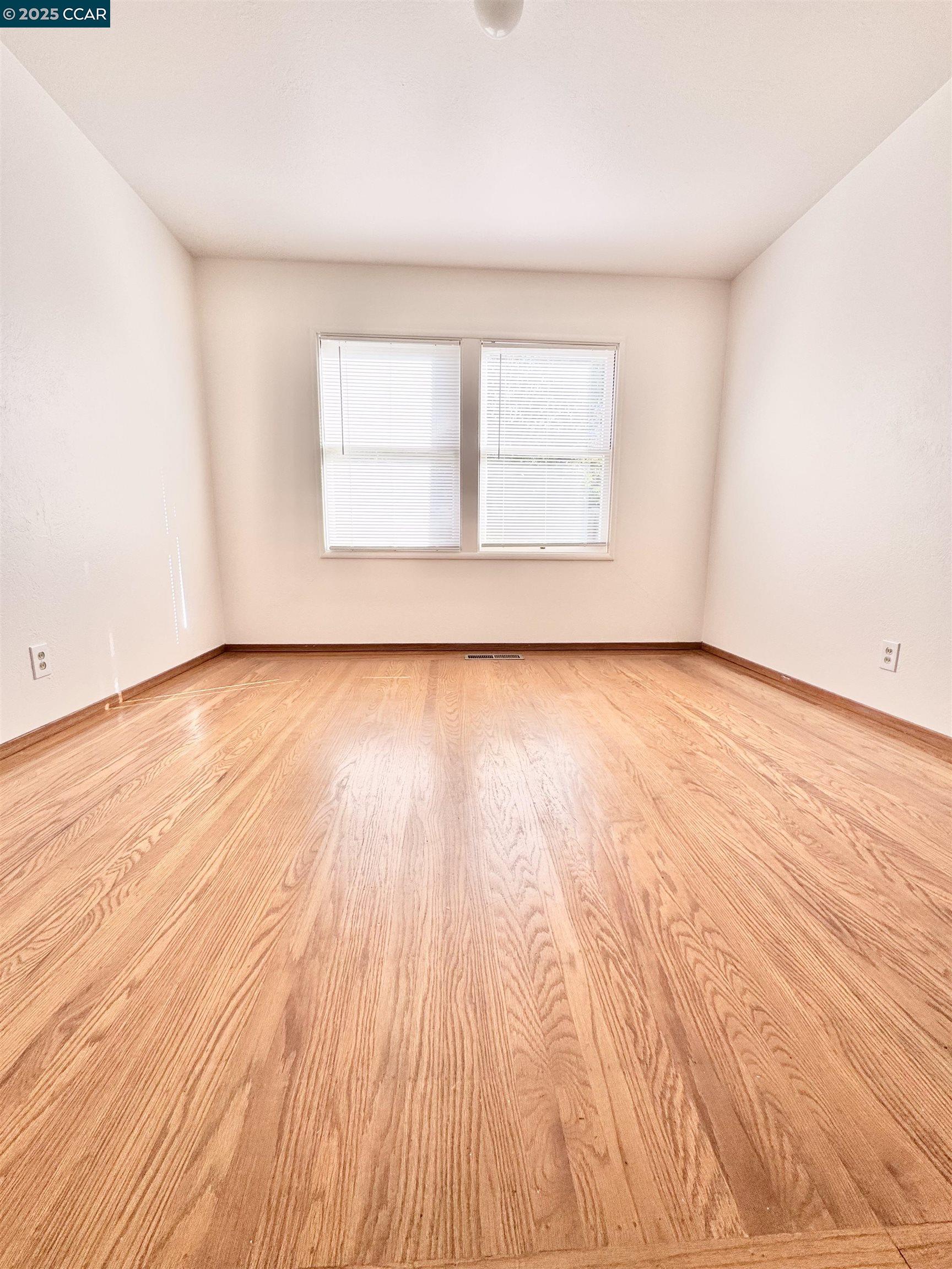 1834 Venice Drive Concord, CA 94519 - Photo 8 of 25 an empty room with wooden floor and windows