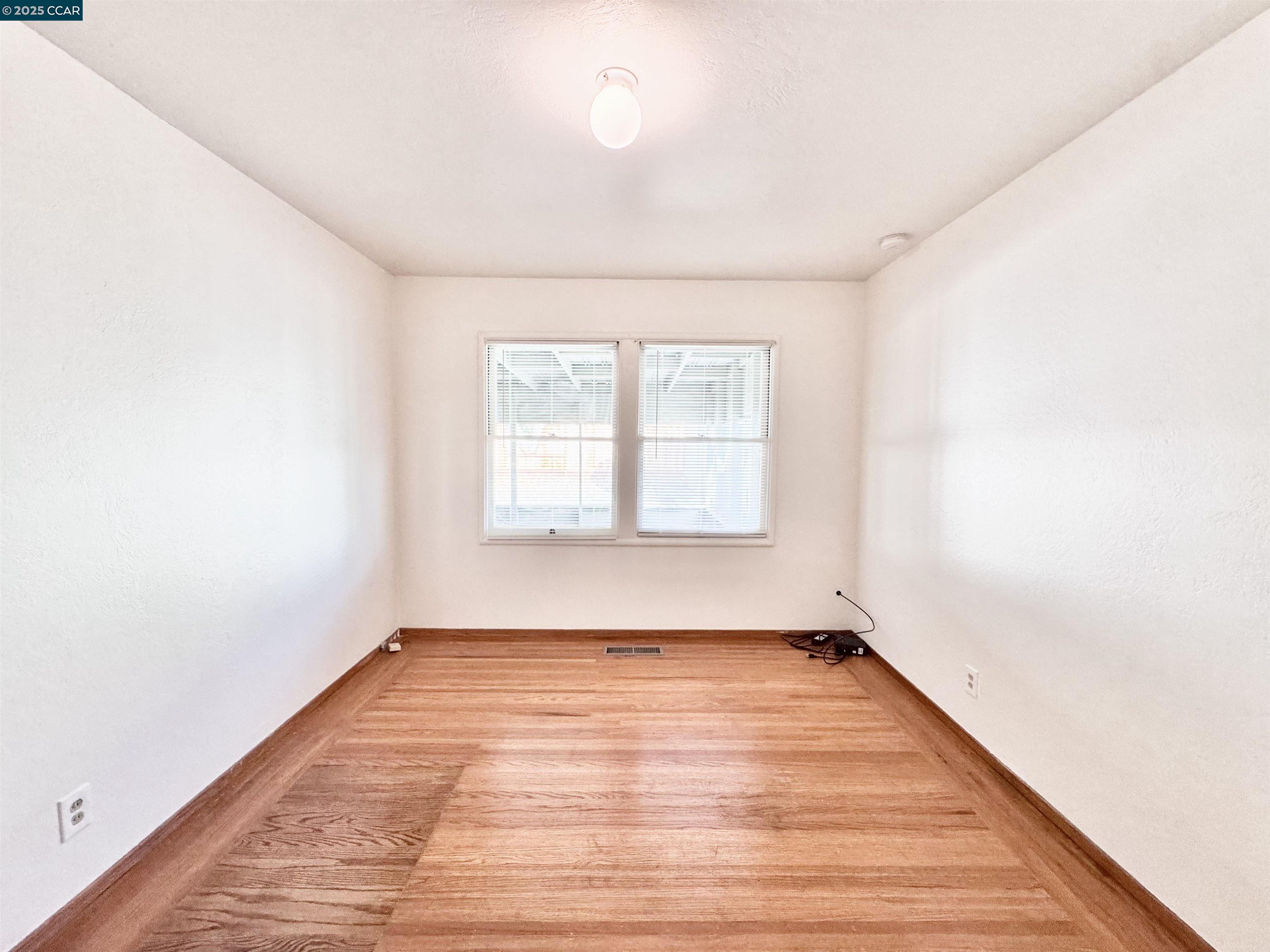 1834 Venice Drive Concord, CA 94519 - Photo 10 of 25 an empty room with wooden floor and windows