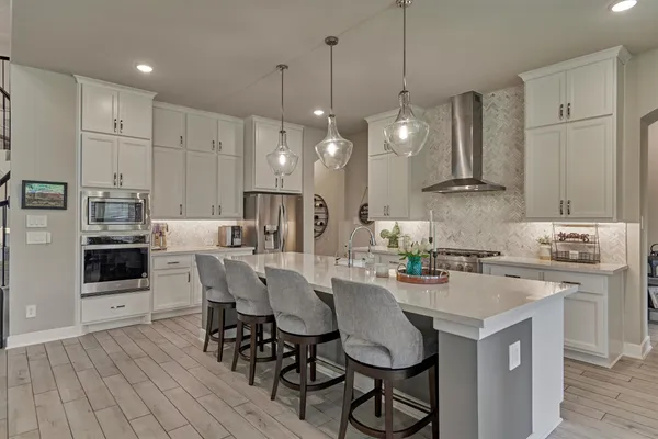 a living room with furniture and a view of kitchen