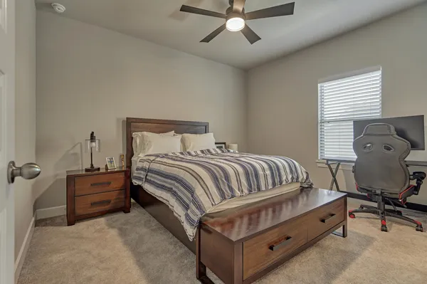 a bedroom with a bed and a chair