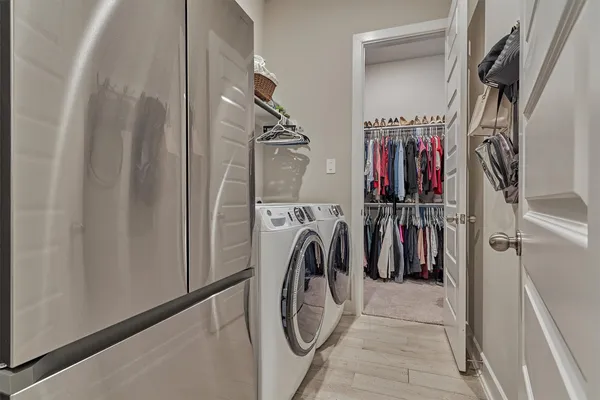 a view of walk in closet with clothes