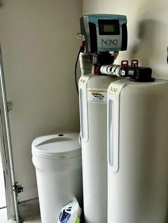 a white toilet sitting next to a sink
